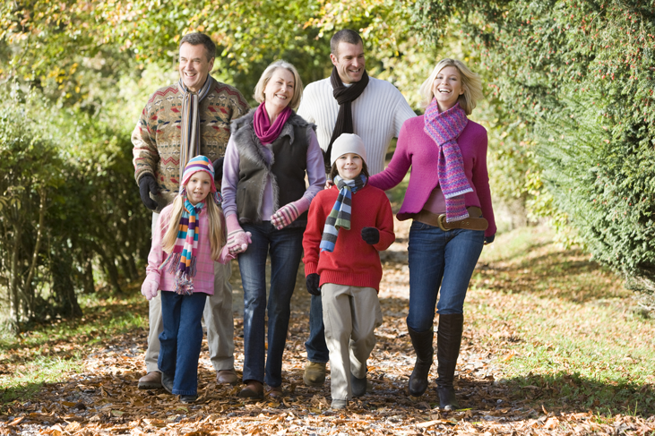 Family walking through the forest with several generations